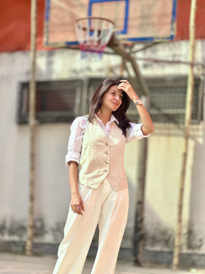 Woman in a light-colored outfit standing on a basketball court
