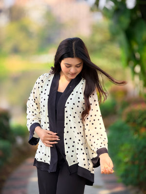Woman wearing a polka dot cardigan in a garden setting