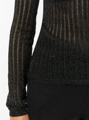 Woman wearing a black textured mesh top which is glittery for party use. trendy buzz bd.