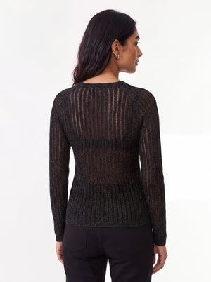 Woman wearing a black textured mesh top which is glittery for party use. trendy buzz bd.