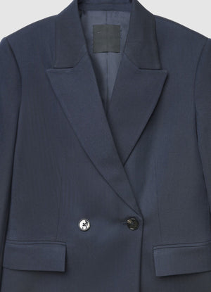 Navy blazer with 'Calliope' label on a light gray background