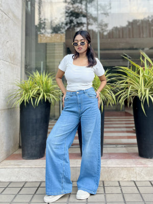 Women's Trendy Wide Leg Jeans in Light Blue with high-waist fit, front and back pockets, belt loops and relaxed wide-leg silhouette by Trendy Buzz.