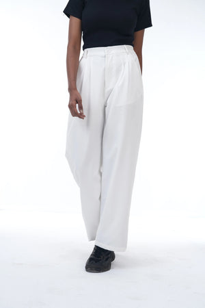 Person wearing white pants and a black top on a white background