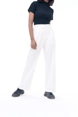 Person wearing a black t-shirt and white pants on a white background