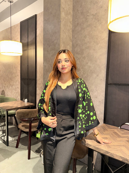 Woman in a Black Green Polka Dot Kimono Outfit in an indoor setting