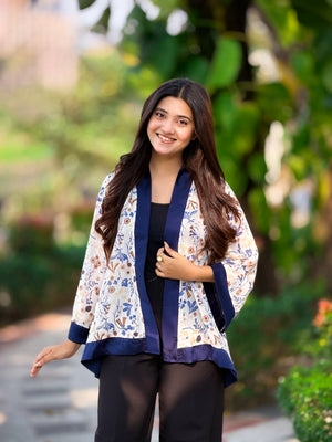Woman wearing a floral jacket with a blurred green background