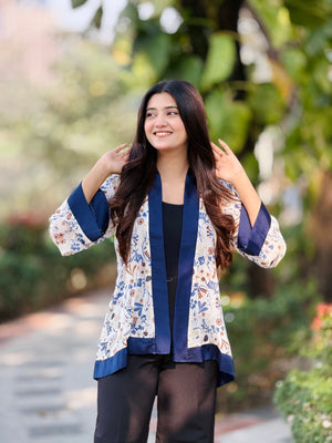 Woman wearing a floral cardigan with blue trim outdoors