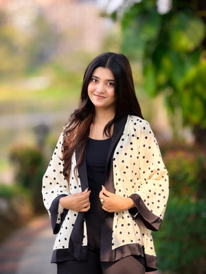 Woman wearing a polka dot cardigan in an outdoor setting
