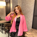 Woman wearing a pink polka dot kimono in an indoor setting