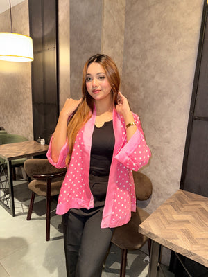 Woman wearing a pink polka dot kimono in an indoor setting