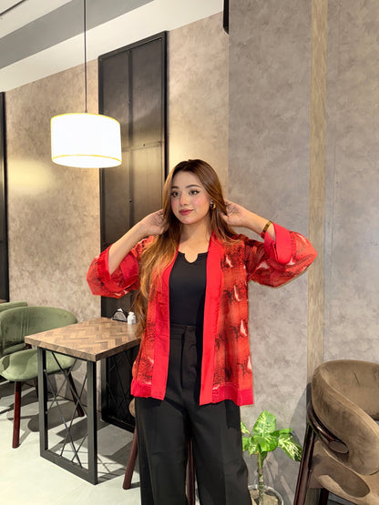 Woman wearing a red snake print kimono in a modern interior setting