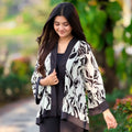 Woman wearing a black and white patterned jacket outdoors