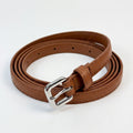 A brown faux leather belt with a silver-tone metal buckle, neatly coiled on a white background.