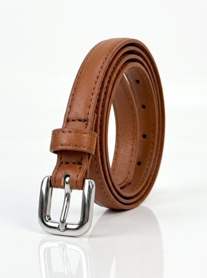 A brown leather belt with a polished silver-tone metal buckle, neatly coiled on a reflective white surface.