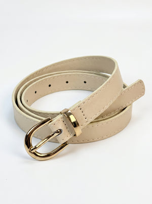 A light beige faux leather belt with a polished gold-tone metal buckle, neatly coiled on a white background.