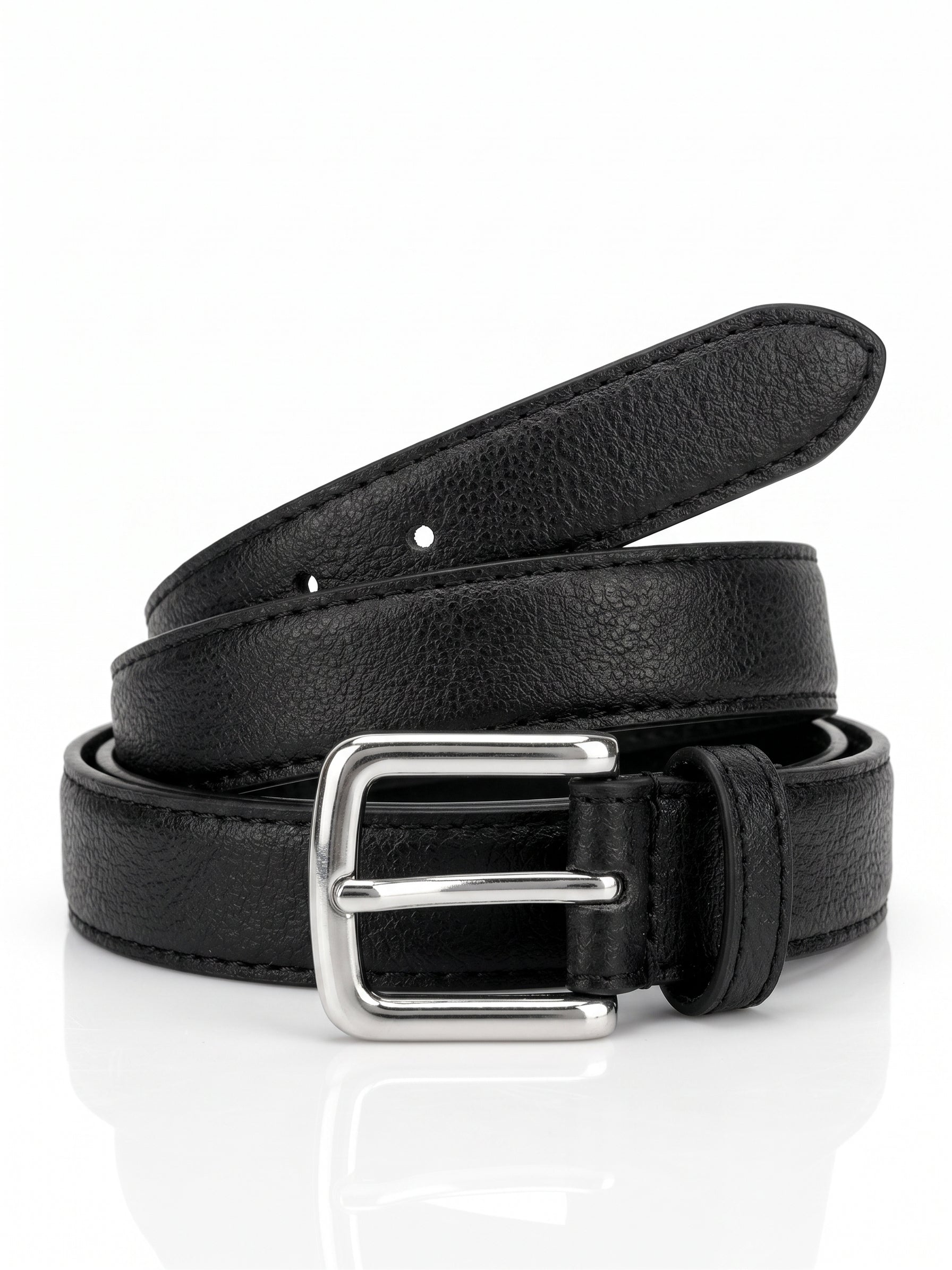 A black pebbled leather belt with a silver-tone metal buckle, neatly coiled on a reflective white surface.