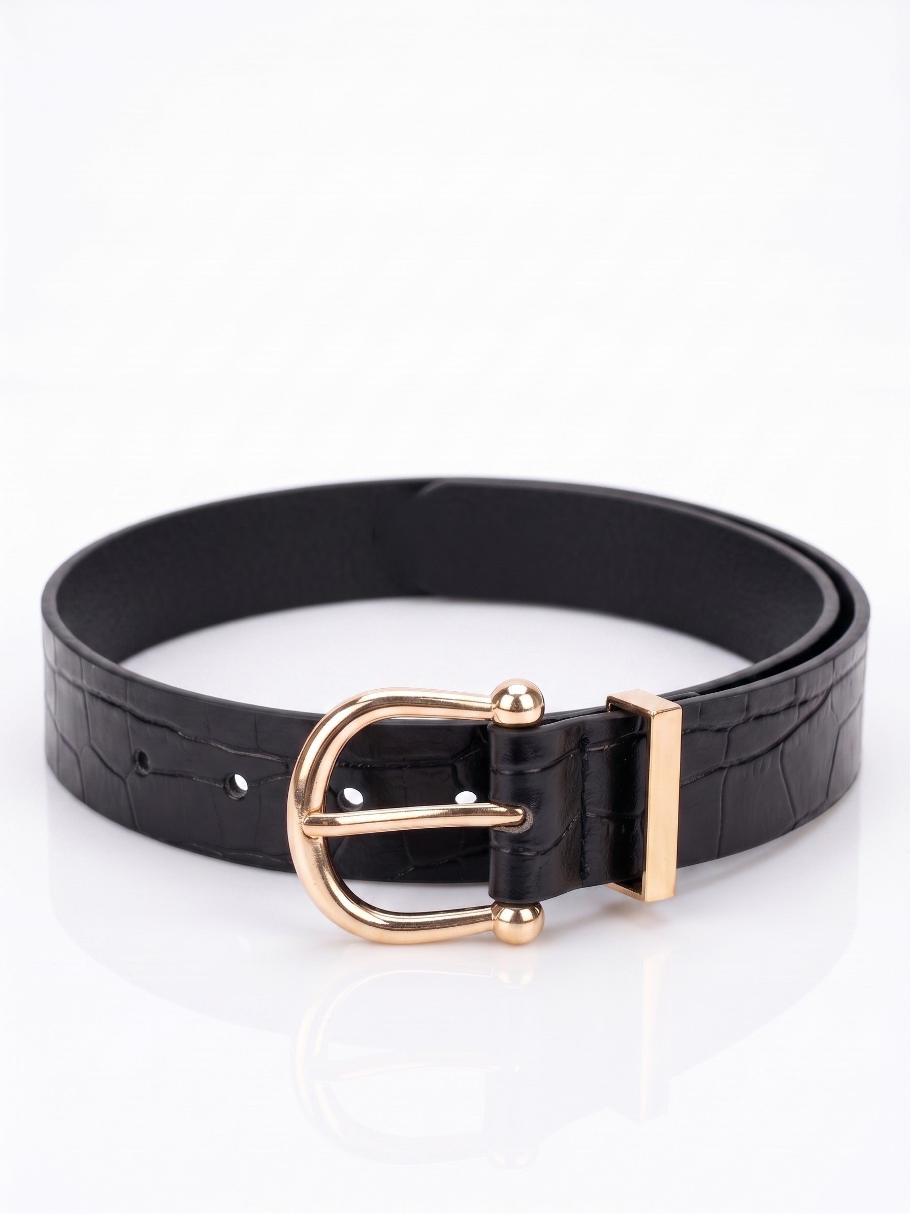 A black faux-crocodile leather belt with a polished gold-tone metal buckle, displayed on a clean white reflective surface.