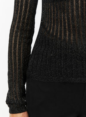 Woman wearing a black textured mesh top which is glittery for party use. trendy buzz bd.