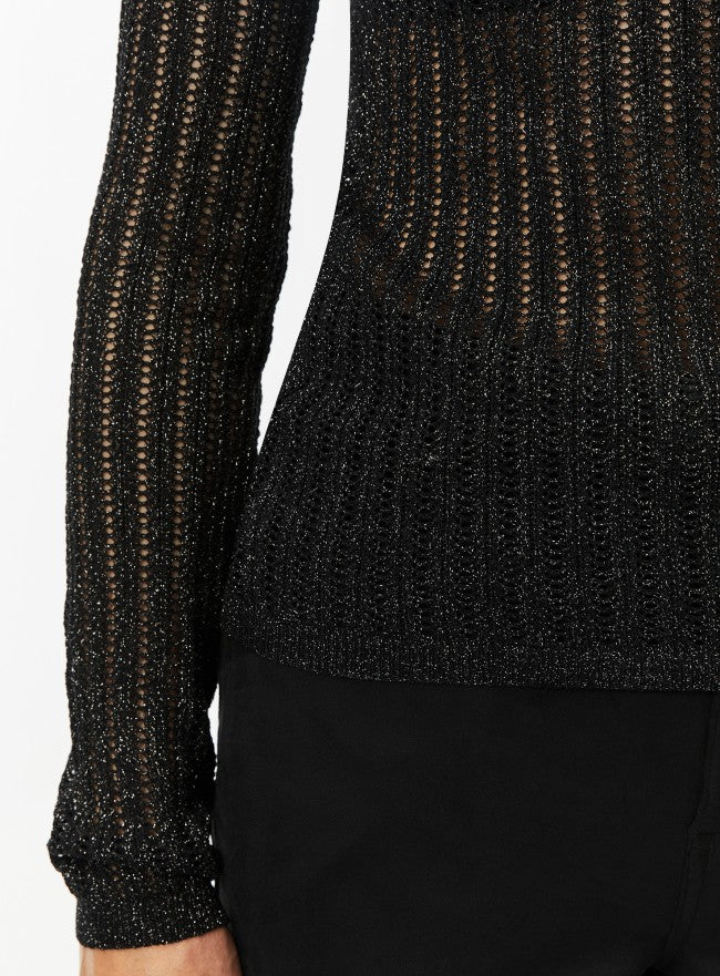 Woman wearing a black textured mesh top which is glittery for party use. trendy buzz bd.