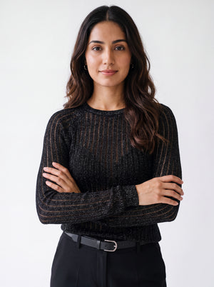 Woman wearing a black textured mesh top which is glittery for party use. trendy buzz bd.