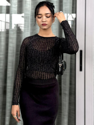 Woman wearing a black textured mesh top which is glittery for party use. Sheer Top. Trendy Buzz.