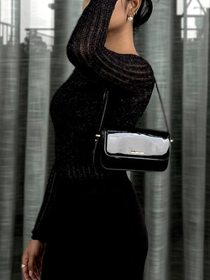 Woman wearing a black textured mesh top which is glittery for party use. Sheer Top. Trendy Buzz.