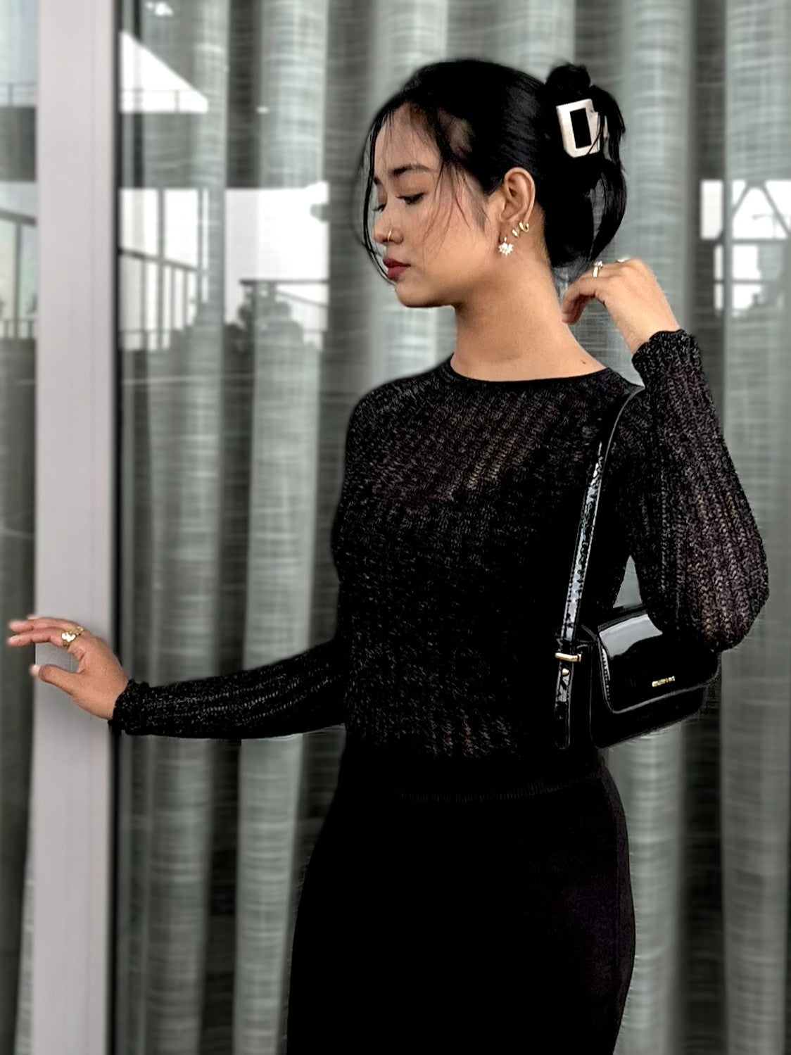 Woman wearing a black textured mesh top which is glittery for party use. Sheer Top. Trendy Buzz.