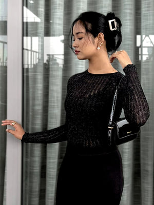Woman wearing a black textured mesh top which is glittery for party use. Sheer Top. Trendy Buzz.