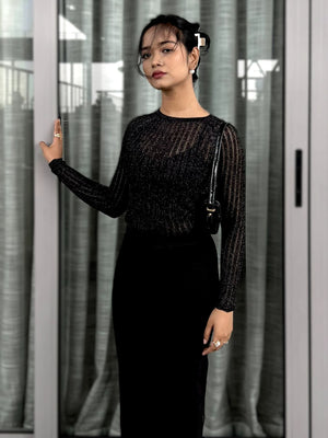 Woman wearing a black textured mesh top which is glittery for party use. Sheer Top. Trendy Buzz.