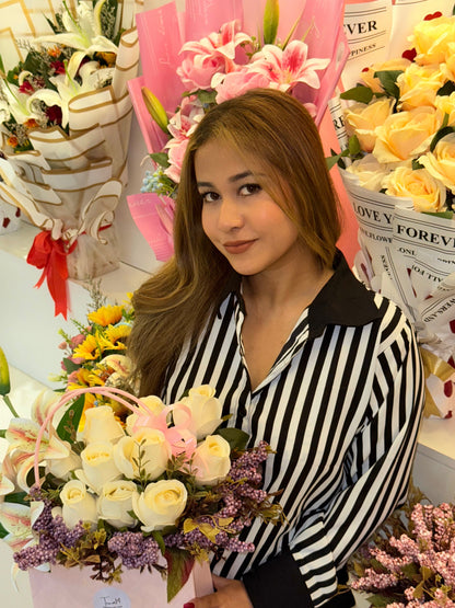 Woman holding a bouquet of flowers surrounded by floral arrangements and decorative items wering Trendy Buzz Black & White Stripe Formal Shirt