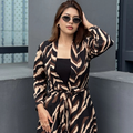 Woman wearing a zebra print Shrug in an urban setting