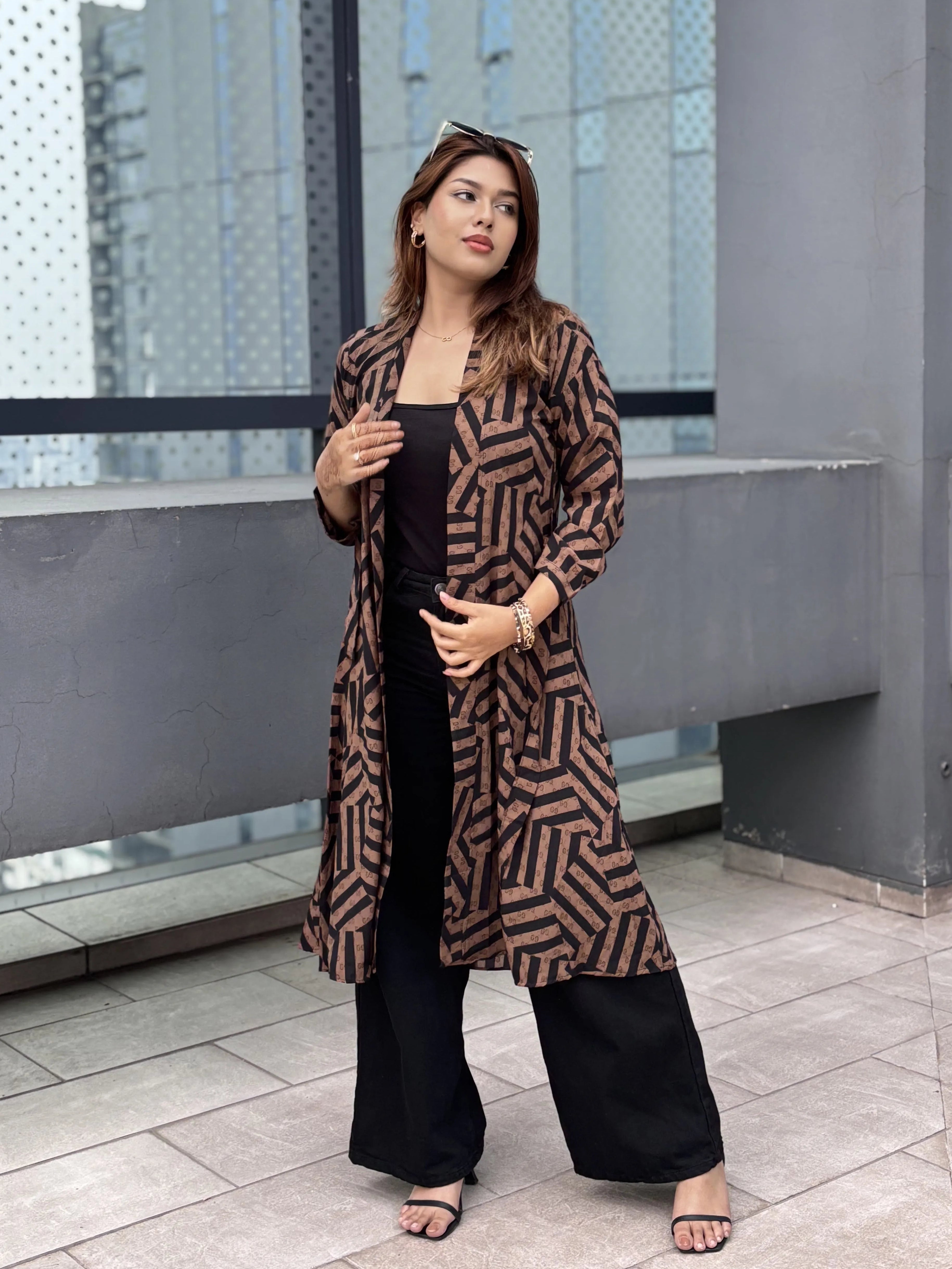 Woman wearing a patterned shrug in an urban setting