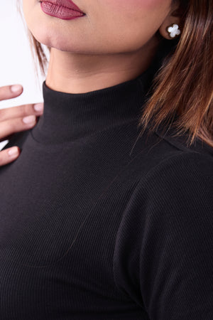 Close-up of a person wearing a black turtleneck sweater.