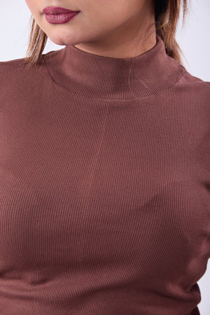 Close-up of a brown ribbed sweater worn by a person.