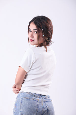 Woman wearing a white t-shirt and blue jeans on a white background
