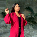 Woman wearing a premium maroon crinkle crepe kimono with textured popcorn fabric