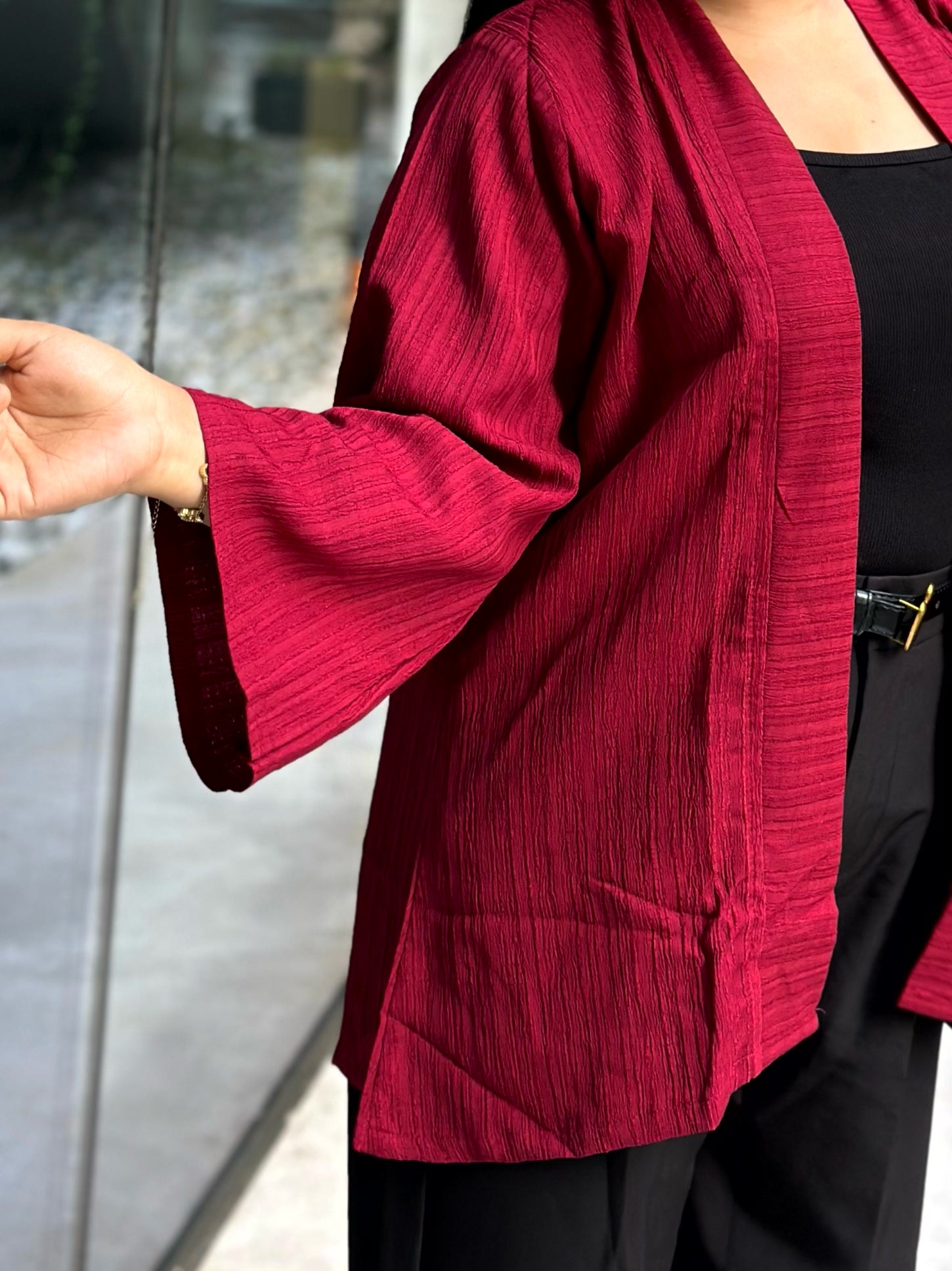 Woman wearing a premium maroon crinkle crepe kimono with textured popcorn fabric