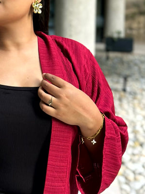 Woman wearing a premium maroon crinkle crepe kimono with textured popcorn fabric