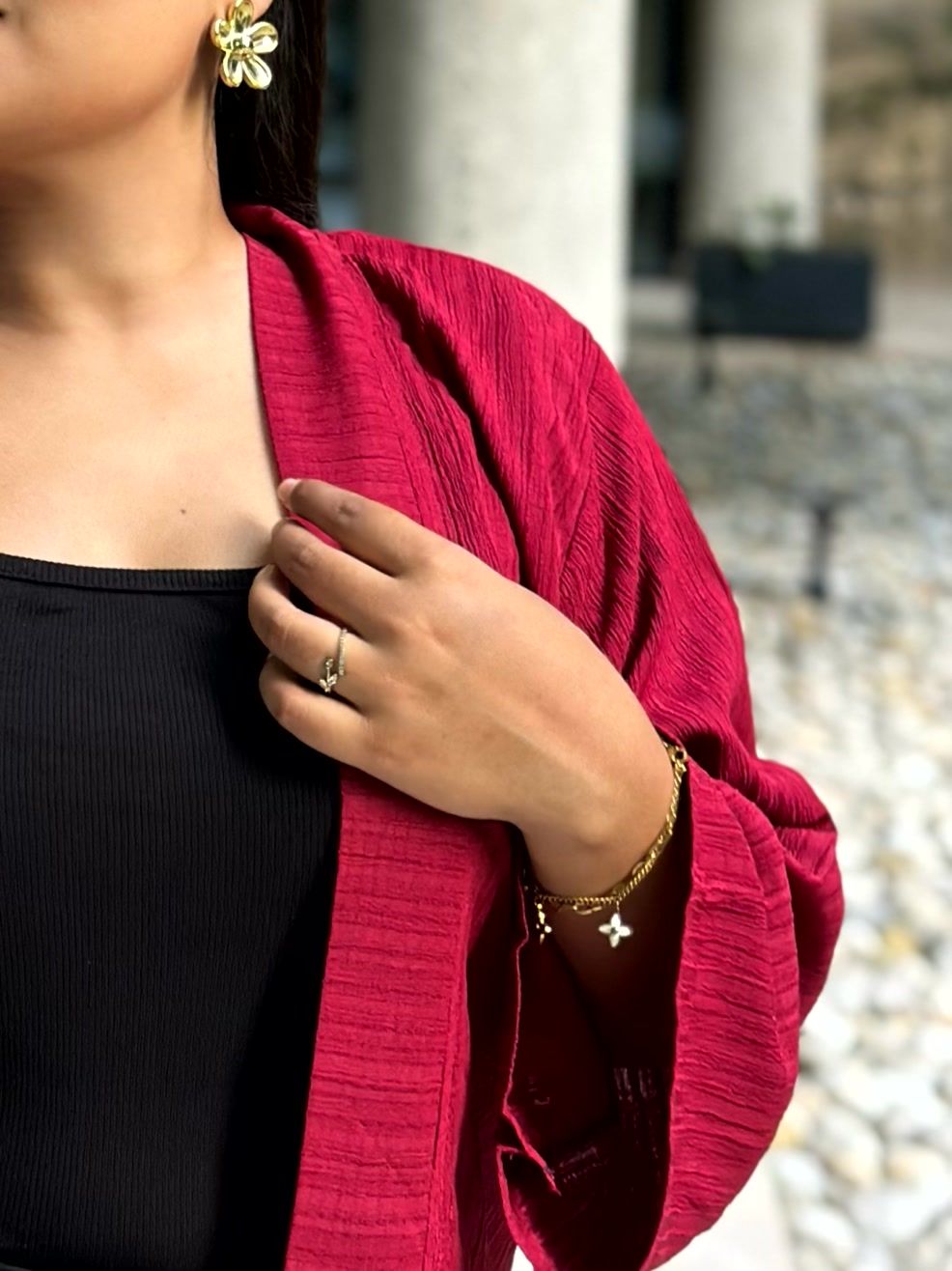 Woman wearing a premium maroon crinkle crepe kimono with textured popcorn fabric