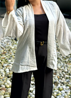 Woman wearing a premium milk white crinkle crepe kimono with textured popcorn fabric