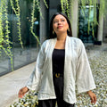 Woman wearing a premium milk white crinkle crepe kimono with textured popcorn fabric