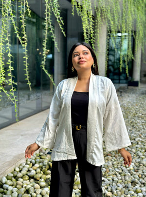 Woman wearing a premium milk white crinkle crepe kimono with textured popcorn fabric