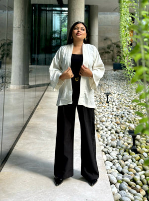 Woman wearing a premium milk white crinkle crepe kimono with textured popcorn fabric