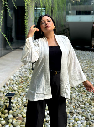 Woman wearing a premium milk white crinkle crepe kimono with textured popcorn fabric