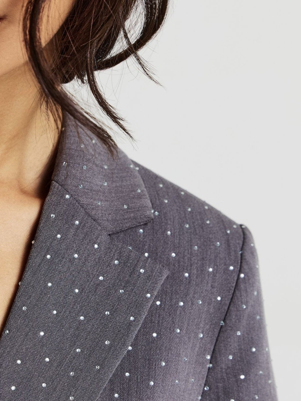 Ladies stone work party blazer in gray color styled with black wide leg pants and black crop top. Trendy Buzz BD.