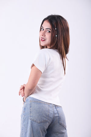 Woman wearing a white t-shirt and blue jeans on a white background