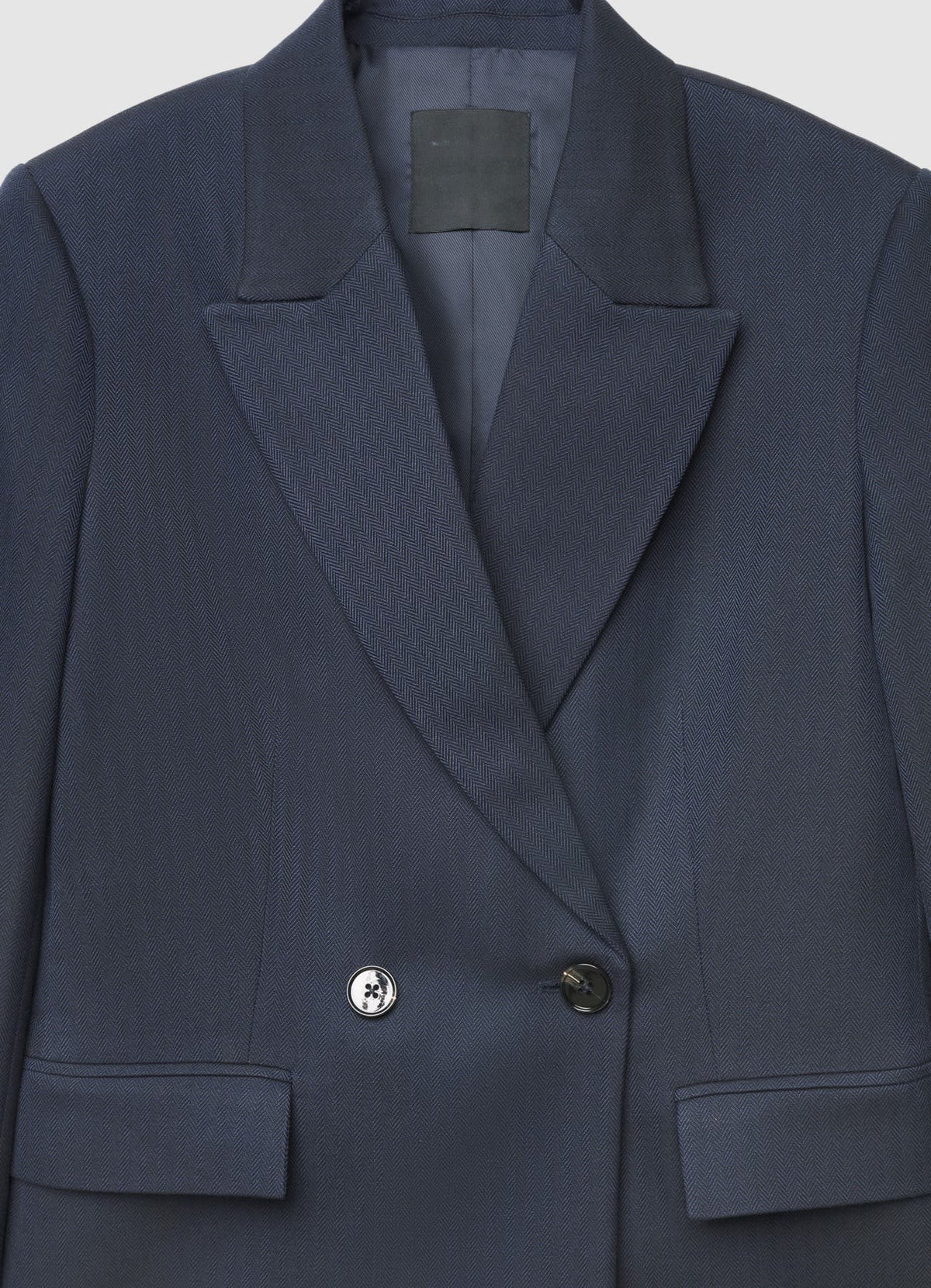 Navy blazer with 'Calliope' label on a light gray background