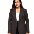 A woman modeling a dark brown double-breasted blazer over a white top and black pants, photographed against a plain white studio background.