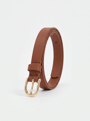 A brown leather belt with a gold-tone metal buckle, coiled and standing upright on a clean white background.