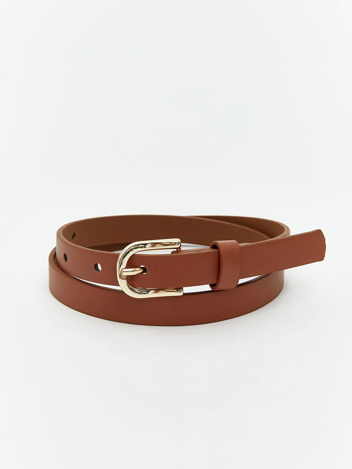 A brown faux leather belt with a gold-tone metal buckle, neatly coiled on a light gray background.